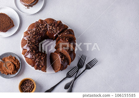 Chocolate cake baked in a bundt pan with chocolate ganache glaze Chocolate cake baked in a bundt pan with chocolate ganache glaze 106155585