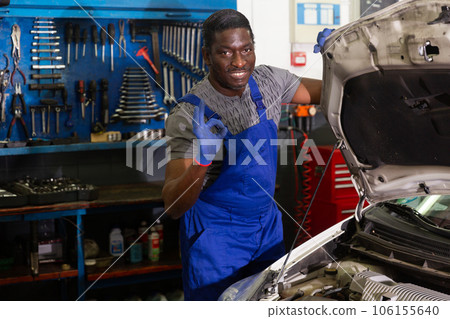 Positive mechanic makes sign that everything is fine Positive mechanic makes sign that everything is fine 106155640
