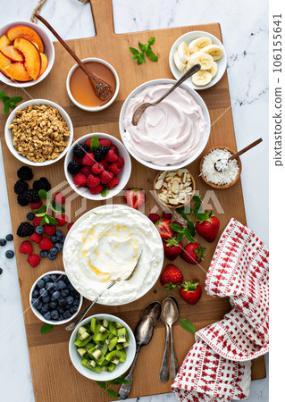 Yogurt bowl bar, big board with different toppings 106155641
