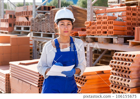 Asian woman manager keeps records of construction materials Asian woman manager keeps records of construction materials 106155675
