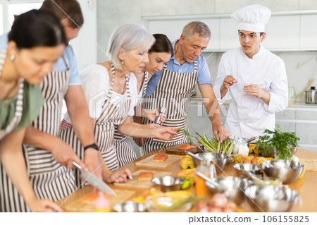 Professional personal chef cook in customer private kitchen house giving cooking lesson to people at home Professional personal chef cook in customer private kitchen house giving cooking lesson to people at home 106155825
