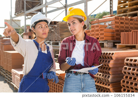 Wokers checking order list at hardware store warehouse Wokers checking order list at hardware store warehouse 106155834