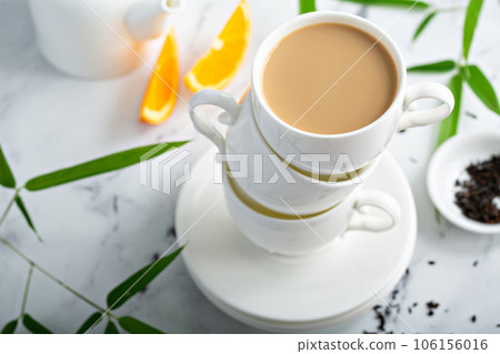 Earl grey milk tea poured in stacked cups Earl grey milk tea poured in stacked cups 106156016