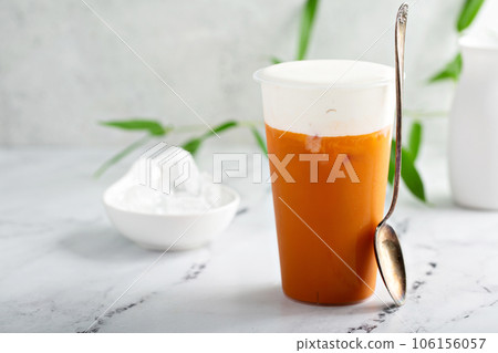 Refreshing mango drink topped with creamy topping Refreshing mango drink topped with creamy topping 106156057