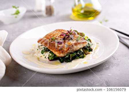Sauteed fish with leafy greens and rice 106156079