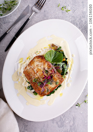 Sauteed fish with leafy greens and rice 106156080