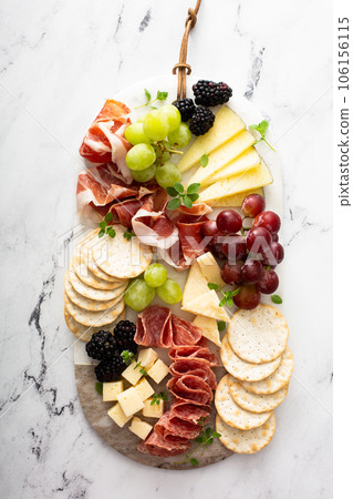 Charcuterie board with variety of cheese and meat Charcuterie board with variety of cheese and meat 106156115