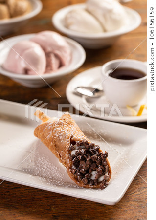 Traditional italian desserts cannoli on the plate 106156159