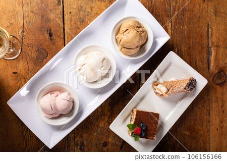 Italian desserts on the table, gelato, tiramisu and cannoli Italian desserts on the table, gelato, tiramisu and cannoli 106156166
