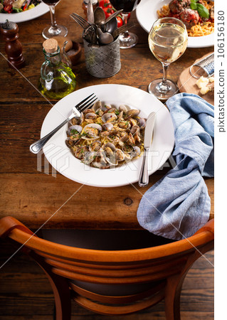 Seafood linguine pasta with clams served with wine Seafood linguine pasta with clams served with wine 106156180