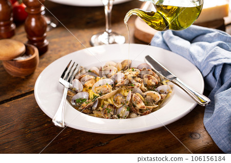 Seafood linguine pasta with clams served with wine Seafood linguine pasta with clams served with wine 106156184