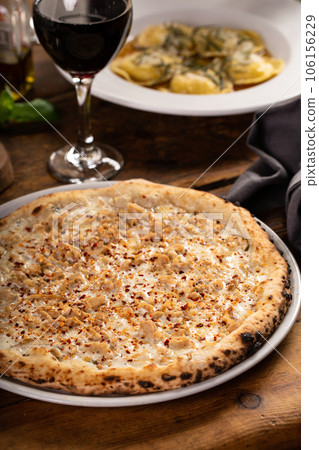 Cheese, clams and chili flakes pizza, freshly baked 106156229