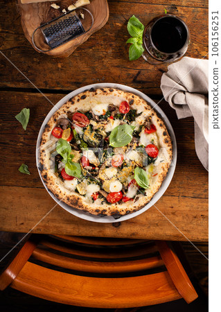 Freshly baked vegetarian Neapolitan pizza with mushrooms and artichokes Freshly baked vegetarian Neapolitan pizza with mushrooms and artichokes 106156251
