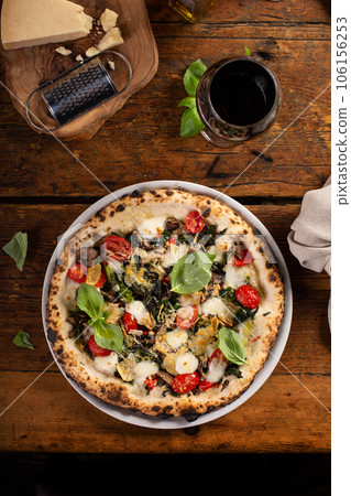 Pizza Napolitana or Naples style with mozzarella, mushrooms and spinach 106156253