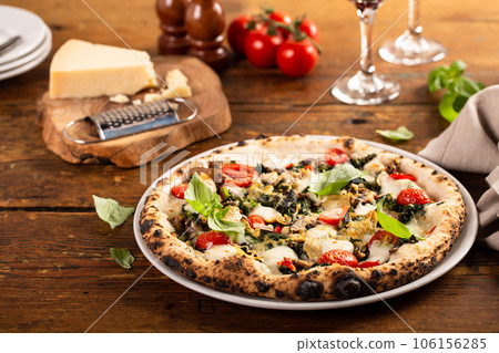 Freshly baked vegetarian Neapolitan pizza with mushrooms and artichokes 106156285