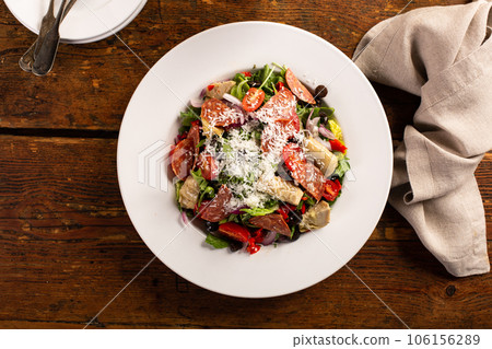 Antipasto salad with salami, artichoke hearts and vegetables 106156289