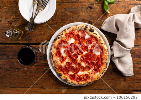Freshly baked Neapolitan pizza with pepperoni and mozzarella Freshly baked Neapolitan pizza with pepperoni and mozzarella 106156292
