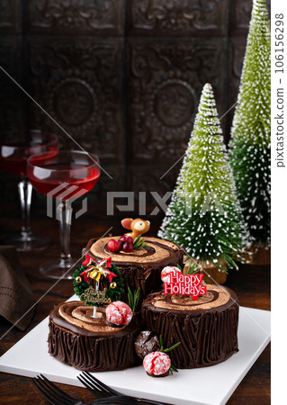 Yule log chocolate cake with frosting for Christmas 106156298