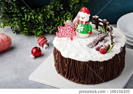 Chocolate Christmas celebration cake with holiday decorations 106156305