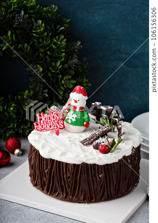 Chocolate Christmas celebration cake with holiday decorations Chocolate Christmas celebration cake with holiday decorations 106156306