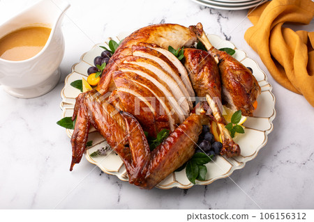 Carved roasted turkey for a celebration dinner 106156312