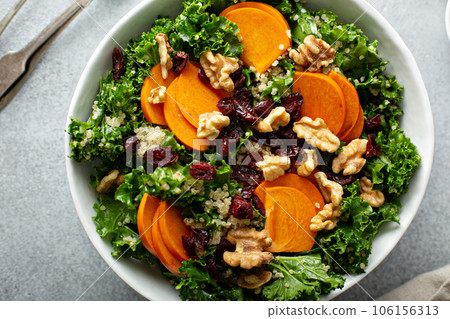 Fall salad with kale, walnuts and persimmon 106156313