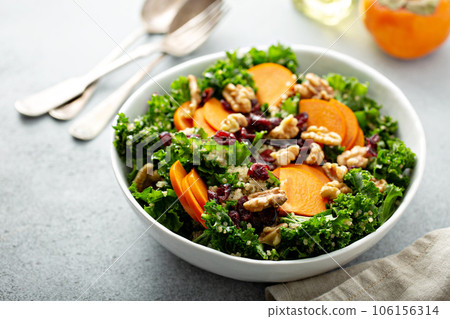 Fall salad with kale, walnuts and persimmon 106156314