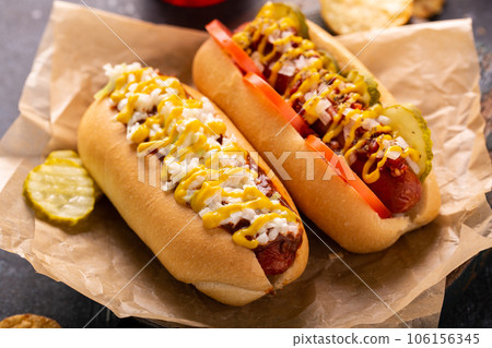 Two hot dogs with ketchup and mustard 106156345