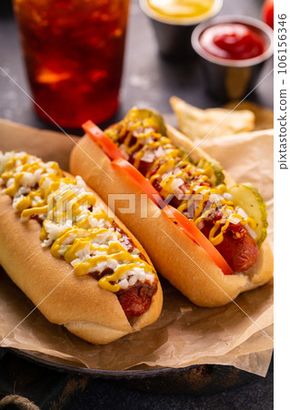 Two hot dogs with ketchup and mustard Two hot dogs with ketchup and mustard 106156346