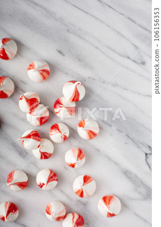 Peppermint meringues on a marble table, Christmas background Peppermint meringues on a marble table, Christmas background 106156353