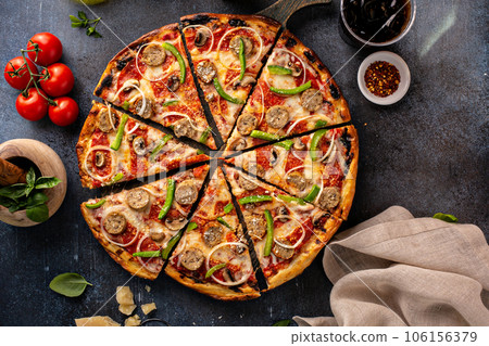 Sausage and vegetable pizza on dark background 106156379