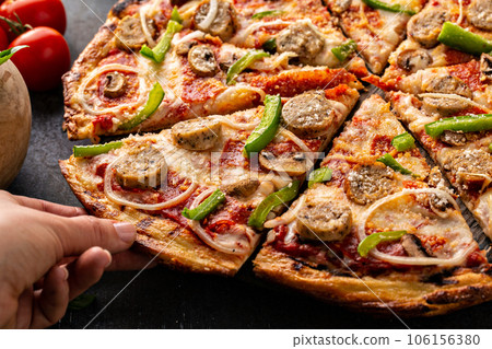 Sausage and vegetable pizza on dark background 106156380