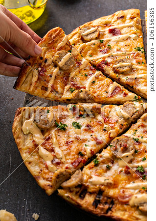 Bacon and sausage pizza on dark background Bacon and sausage pizza on dark background 106156385