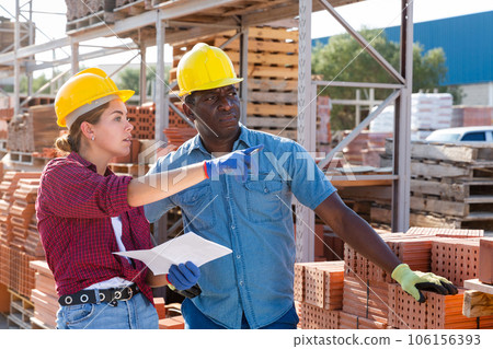 Two storekeepers with an estimate in their hands discuss working issues in the warehouse Two storekeepers with an estimate in their hands discuss working issues in the warehouse 106156393