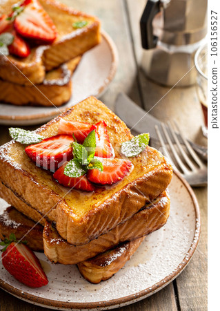 French toasts with strawberry and powdered sugar French toasts with strawberry and powdered sugar 106156527