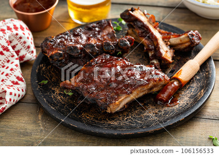 Grilled barbeque ribs with BBQ sauce and sides 106156533