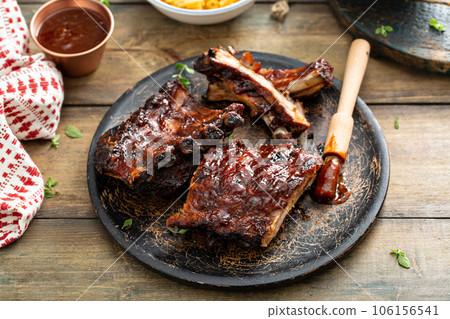 Grilled barbeque ribs with BBQ sauce and sides 106156541