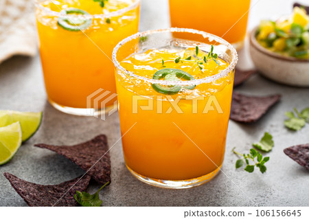 Pineapple and mango margarita with chips and guacamole Pineapple and mango margarita with chips and guacamole 106156645