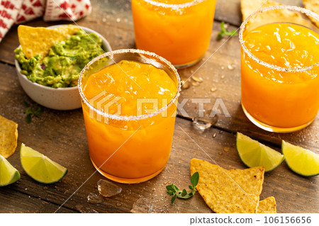 Pineapple and mango margarita with chips and guacamole Pineapple and mango margarita with chips and guacamole 106156656