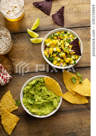 Tortilla chips with dips, guacamole and salsa 106156664