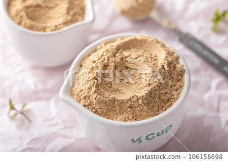 Maca powder in measuring cups and a spoon Maca powder in measuring cups and a spoon 106156698