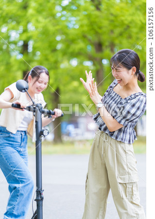 Image of an electric kickboard on which a young woman rides causes a traffic accident with a pedestrian | Traffic accident image 106157156