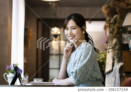 A young woman working at a cafe looking at the camera 106157248