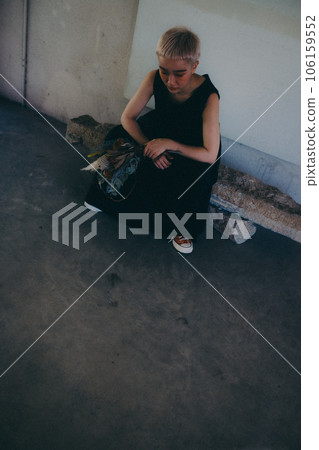 A woman standing indoors with dried flowers 106159552