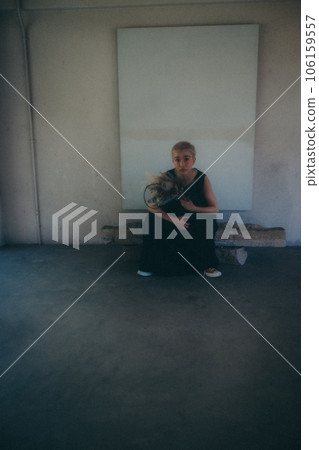 A woman standing indoors with dried flowers A woman standing indoors with dried flowers 106159557