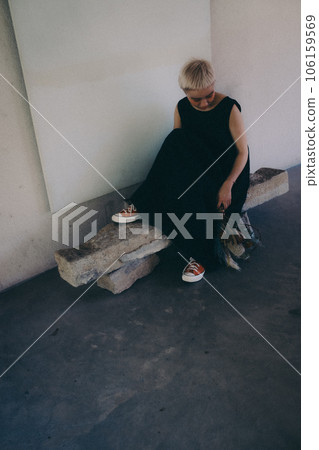 A woman standing indoors with dried flowers 106159569