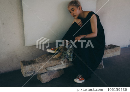 A woman standing indoors with dried flowers 106159586