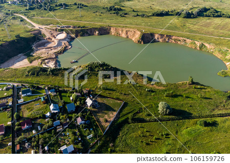 Aerial view of a flooded sand pit in the village of Trekhsvyatskoye, Zhukovsky district, Kaluga region, Russia Aerial view of a flooded sand pit in the village of Trekhsvyatskoye, Zhukovsky district, Kaluga region, Russia 106159726