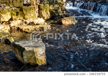 Separated block of marl rock on the river bank Separated block of marl rock on the river bank 106159755