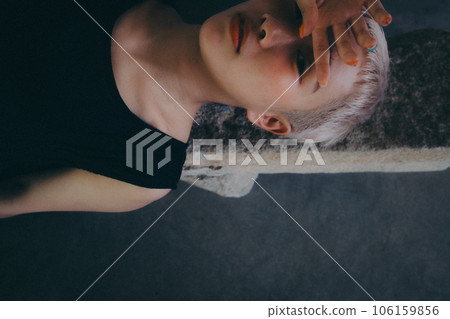 woman lying indoors woman lying indoors 106159856